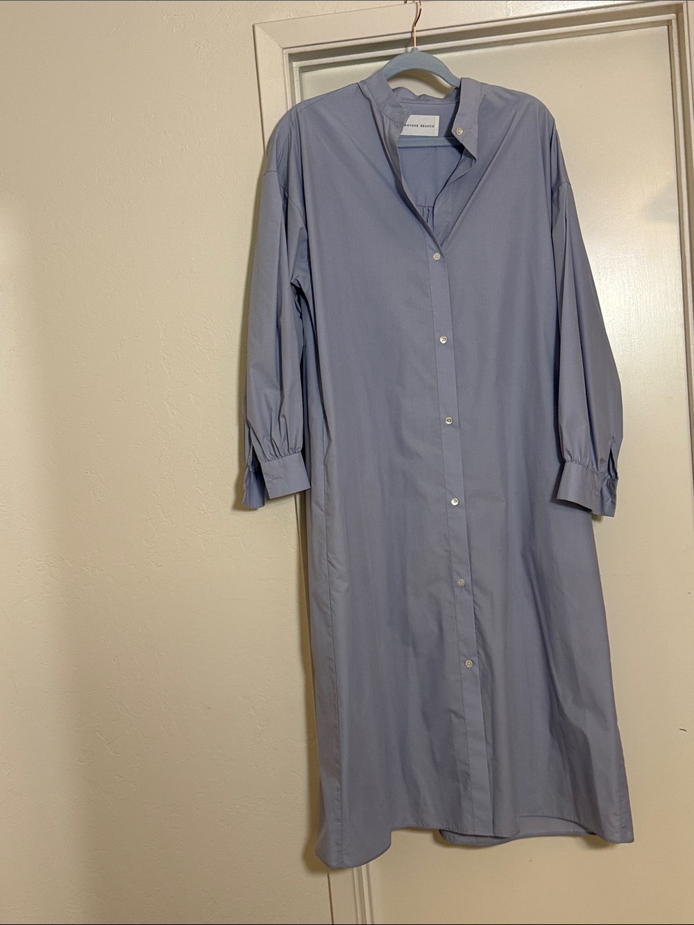 Relaxed, with formal tailoring, shirt dress.